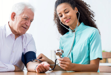 nurse checking senior's blood pressure